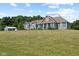 Sprawling home with manicured lawn, dormer windows, and board and batten outbuilding at 9083 W Koger Ln, Martinsville, IN 46151