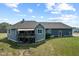 Back view of a home with a deck, covered patio, and outdoor firepit area at 9083 W Koger Ln, Martinsville, IN 46151