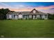 This home features a well-manicured lawn and inviting front porch with columns at 9083 W Koger Ln, Martinsville, IN 46151