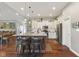 The kitchen has an island with barstool seating, pendant lights, and stainless-steel appliances at 9083 W Koger Ln, Martinsville, IN 46151