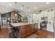 This open-concept kitchen features a center island, stainless-steel appliances, and ample cabinet space at 9083 W Koger Ln, Martinsville, IN 46151