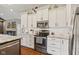 Bright kitchen with granite countertops, stainless steel appliances, and white cabinets at 9083 W Koger Ln, Martinsville, IN 46151