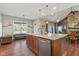Open-concept kitchen with island seating, stainless appliances, and hardwood floors at 9083 W Koger Ln, Martinsville, IN 46151