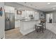 Modern kitchen featuring white cabinets, stainless steel appliances, and a breakfast bar at 9083 W Koger Ln, Martinsville, IN 46151
