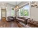 Comfortable living room featuring plush leather seating and plenty of natural light from large windows at 9083 W Koger Ln, Martinsville, IN 46151