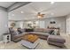 Open-concept living room area with sectional sofa, wood accents, and recessed lighting at 9083 W Koger Ln, Martinsville, IN 46151