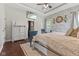 Spacious main bedroom featuring tray ceiling, accent wall, and a wall-mounted television at 9083 W Koger Ln, Martinsville, IN 46151