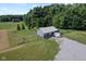 The yard features an outbuilding with an adjacent fenced-in area and garden at 9083 W Koger Ln, Martinsville, IN 46151