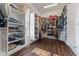 Organized walk-in closet featuring extensive shelving and hanging space; hardwood floor at 9083 W Koger Ln, Martinsville, IN 46151