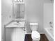 Clean bathroom with white toilet and bathtub, and dark hardwood floor at 2013 Angel Tear Ct, Indianapolis, IN 46231