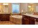 Spa-like bathroom with double vanity, large soaking tub, and tile flooring at 621 Greenford W Trl, Carmel, IN 46032