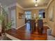 Formal dining room with hardwood floors and a view into the living room and kitchen at 621 Greenford W Trl, Carmel, IN 46032