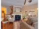 Bright living room with fireplace, hardwood floors, and large windows at 621 Greenford W Trl, Carmel, IN 46032
