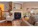 Cozy living room with fireplace, hardwood floors, and comfortable seating at 621 Greenford W Trl, Carmel, IN 46032