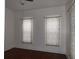 Bright bedroom with hardwood floors and two windows at 25 W Pennsylvania St, Shelbyville, IN 46176