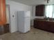 White refrigerator in kitchen with wood cabinets and tile floor at 25 W Pennsylvania St, Shelbyville, IN 46176