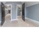 Bedroom with two open doors leading to hallway and closet at 2101 N Wolf Cv, Martinsville, IN 46151