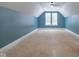Large bonus room with sloped ceilings and two windows at 2101 N Wolf Cv, Martinsville, IN 46151