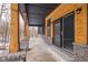 Covered porch with sliding glass door leading to the interior, offering wooded views at 2101 N Wolf Cv, Martinsville, IN 46151