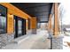 Spacious covered porch with wooden posts and gray brick base; snowy landscape visible at 2101 N Wolf Cv, Martinsville, IN 46151