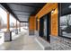 Covered porch with wooden posts and gray brick base, offering views of the backyard at 2101 N Wolf Cv, Martinsville, IN 46151