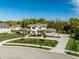 Aerial view of a well-maintained home featuring lush landscaping and a circular driveway at 340 Beechwood Farm Ln, Indianapolis, IN 46260