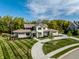 Stunning aerial view of a luxury home with a lush green lawn and circular driveway at 340 Beechwood Farm Ln, Indianapolis, IN 46260