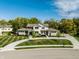 Beautiful home featuring a well-manicured lawn, circular driveway, and stone accents at 340 Beechwood Farm Ln, Indianapolis, IN 46260