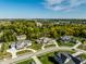 A gorgeous aerial view shows lush trees lining a community of homes with spacious landscaped lawns at 340 Beechwood Farm Ln, Indianapolis, IN 46260