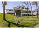 Modern home exterior featuring a walkout basement, covered patio, and expansive windows at 340 Beechwood Farm Ln, Indianapolis, IN 46260