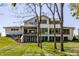 Modern home exterior boasts large windows, a covered patio, and landscaped backyard at 340 Beechwood Farm Ln, Indianapolis, IN 46260