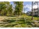 Spacious backyard with lush lawn and mature trees, offering privacy and serenity at 340 Beechwood Farm Ln, Indianapolis, IN 46260