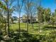 A serene backyard view featuring a lush lawn and mature trees at 340 Beechwood Farm Ln, Indianapolis, IN 46260