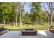 Spacious backyard featuring a stone fire pit, lush lawn, and mature trees at 340 Beechwood Farm Ln, Indianapolis, IN 46260