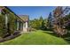 Landscaped backyard features a large lawn, patio, and a metal elephant sculpture at 340 Beechwood Farm Ln, Indianapolis, IN 46260