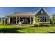 Well-maintained backyard with a large lawn, patio, and a metal elephant sculpture near the house at 340 Beechwood Farm Ln, Indianapolis, IN 46260