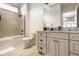 Well-lit bathroom featuring a double vanity, granite countertop, and glass shower at 340 Beechwood Farm Ln, Indianapolis, IN 46260