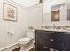 Stylish powder room featuring a modern vanity, granite countertop, and decorative barn door at 340 Beechwood Farm Ln, Indianapolis, IN 46260