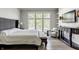 Bedroom boasts a large window, stylish furniture, and hardwood floors at 340 Beechwood Farm Ln, Indianapolis, IN 46260