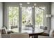 Dining room features large windows, stylish lighting, and a round table with seating for six at 340 Beechwood Farm Ln, Indianapolis, IN 46260