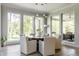 Bright dining room featuring a round table, modern pendant lighting, and large windows overlooking a wooded area at 340 Beechwood Farm Ln, Indianapolis, IN 46260