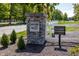 Oak Park community entrance with stone signage, white fence, and manicured landscaping at 340 Beechwood Farm Ln, Indianapolis, IN 46260