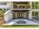 Exterior view of the back of a house with a covered patio, firepit, and landscaped yard at 340 Beechwood Farm Ln, Indianapolis, IN 46260