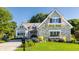 Charming stone-faced house with a well-manicured lawn and beautiful landscaping at 340 Beechwood Farm Ln, Indianapolis, IN 46260