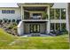 Back of house showcasing covered patio, firepit, landscaped yard and brick facade at 340 Beechwood Farm Ln, Indianapolis, IN 46260