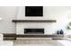 Close-up of a modern fireplace with a white textured surround and dark wood mantle at 340 Beechwood Farm Ln, Indianapolis, IN 46260
