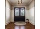 Elegant foyer featuring a decorative front door, hardwood floors, and wainscoting at 340 Beechwood Farm Ln, Indianapolis, IN 46260