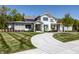 Charming two-story house features an elegant exterior, a spacious lawn, and a winding driveway at 340 Beechwood Farm Ln, Indianapolis, IN 46260