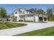 Stunning two-story home showcasing stone and siding, a large driveway, and professional landscaping at 340 Beechwood Farm Ln, Indianapolis, IN 46260