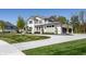 Beautiful two-story house boasts lush green lawn, a curved driveway, and exterior architectural details at 340 Beechwood Farm Ln, Indianapolis, IN 46260